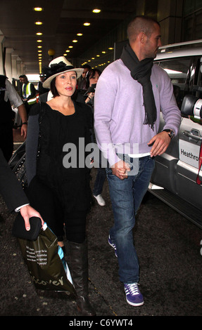 Dannii Minogue and her partner Kris Smith arrive at Heathrow Airport London, England - 12.04.10 Stock Photo