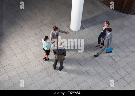 Business people talking in courtyard Stock Photo