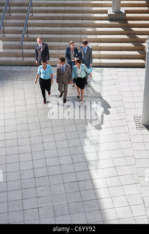 Business people walking in courtyard Stock Photo