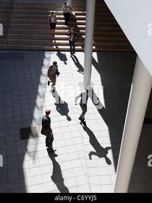 Business people walking in courtyard Stock Photo