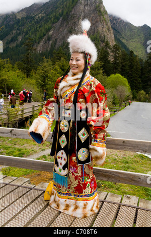 Chinese middle class tourist / tourists wearing Tibetan national costume at Jiuzhaigou National Scenic Area / park, Sichuan Province, China. Stock Photo