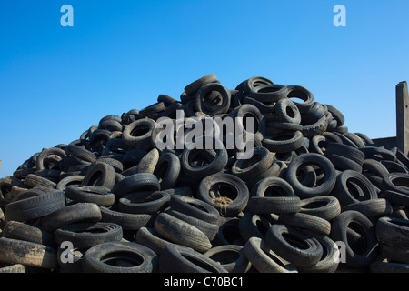 Pile of old tires under blue sky Stock Photo