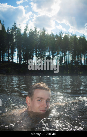 Man swimming in rural lake