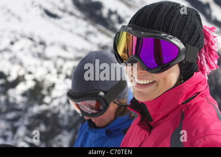 Smiling woman wearing ski goggles Stock Photo