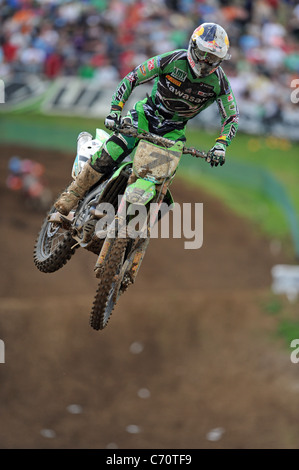 A Motocross Rider jumps through the air on an MX Bike. Stock Photo