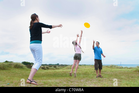 Family playing with frisbee outdoors Stock Photo