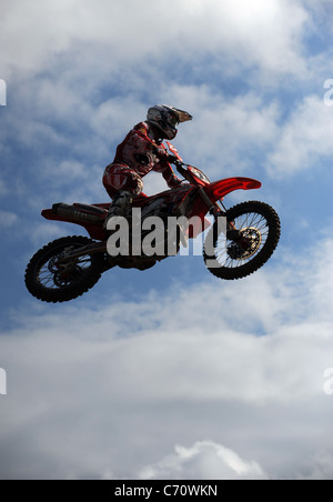 Silhouette of a Motocross Racer jumping on an MX Bike Stock Photo