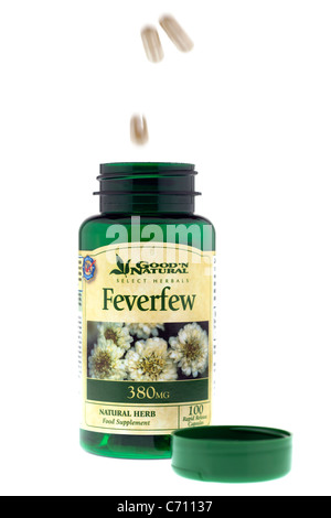 Food supplement capsules falling into a 380mg bottle of Good and Natural Feverfew Bottle Stock Photo