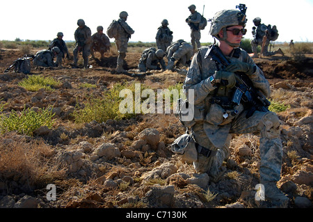 U.S. Army Spc. Edward Brodzinski provides security while other soldiers unearth a weapons cache in the rural region of Zoba, Iraq, on Oct. 4, 2008. Brodzinski and the soldiers are assigned to 1st Battalion, 27th Infantry Regiment, 2nd Stryker Brigade Combat Team, 25th Infantry Division. The site is known to hold numerous hidden weapons caches. DoD photo by Spc. Daniel Herrera, U.S. Army. (Released) Stock Photo