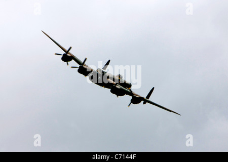 WW2 British RAF Avro Lancaster Bomber Plane on a pass over an airfield during an Airshow Stock Photo