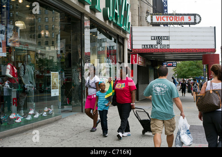 Pedestrians near the shuttered Victoria Theater in Harlem in New York Stock Photo