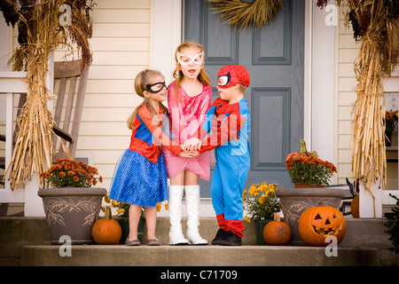 Excited children dressed up in costumes for Halloween Stock Photo