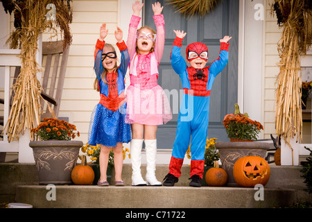 Excited children dressed up in costumes for Halloween Stock Photo