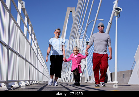 A family takes a stroll down the Arthur Ravenel Bridge in Charleston, South Carolina to have an active healthy lifestyle. Stock Photo