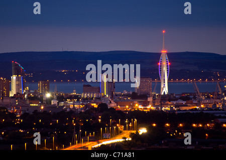 A panoramic view of Portsmouth city at night showing the Spinnaker Tower and the Isle of Wight in the distance. Stock Photo