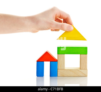 Wooden block houses under construction isolated on white background Stock Photo