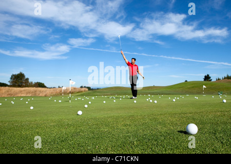Man excited about making a putt while golfing. Stock Photo