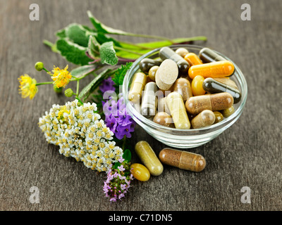 Herbs with alternative medicine herbal supplements and pills Stock Photo