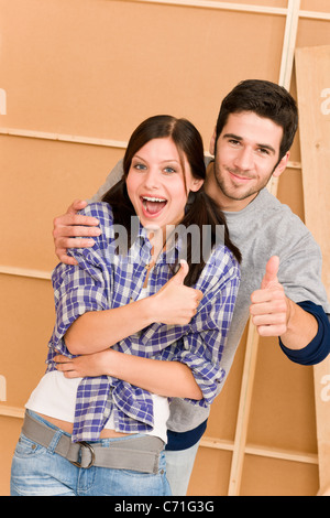 Home improvement young couple having fun new house thumb up Stock Photo