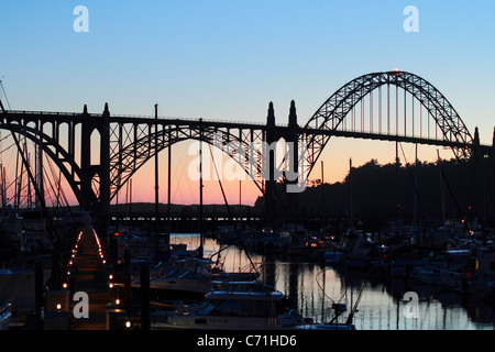 Sunset on Yaquina Bay Bridge in Newport, Oregon on the Oregon Coast on Highway 101. Bridge was designed by Conde McCullough. Stock Photo