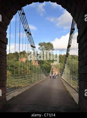 Family crossing the Chain Bridge or Union Bridge, between Horncliffe in England and Fishwick in Scotland spans the river Tweed. Stock Photo