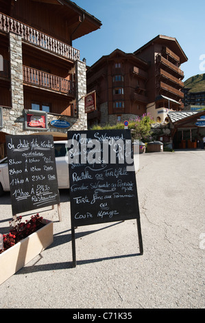 Menu board with local dishes outside restaurant in the French alpine village of Belle Plagne in summer Stock Photo