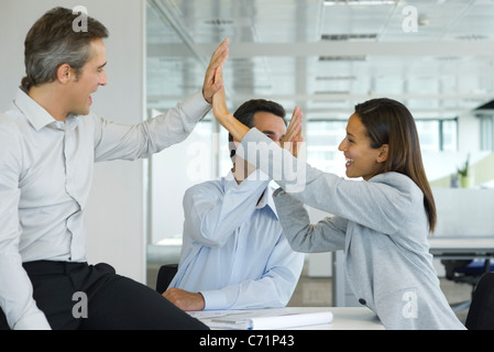 Colleagues giving high-five Stock Photo