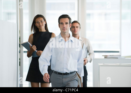 Executives walking in office Stock Photo