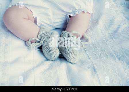 Baby with knitted booties, low section Stock Photo