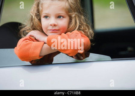 Little girl looking out car window, portrait Stock Photo