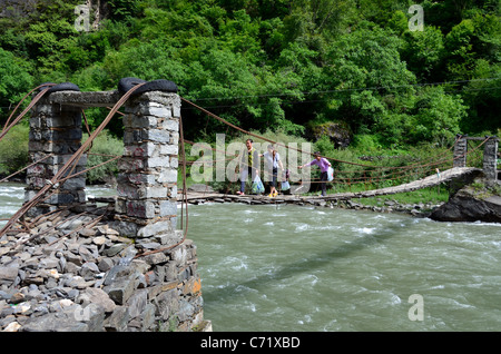 A primitive hanging bridge across treacherous river. Sichuan, China. Stock Photo