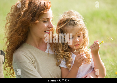 Mother and young daughter relaxing together outdoors Stock Photo
