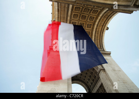France, Paris, Etoile, French flag under Arc de Triomphe built by Napoleon Stock Photo