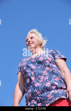 A portrait of a senior woman, smiling (blond hair / blue green eyes) Stock Photo