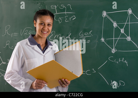 adult teacher is standing near chalkboard Stock Photo