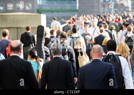 London Bridge back view close up three men in suits two balding office workers walk towards London Bridge station during evening rush hour England UK Stock Photo