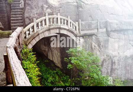 Foggy Stone bridge in Huangshan mountains, China Stock Photo