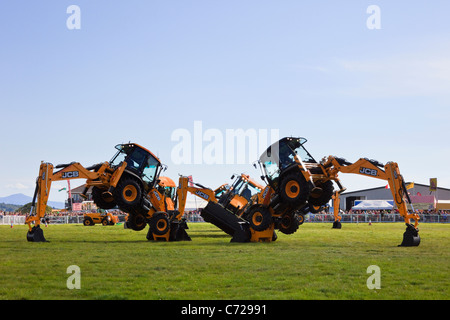 Mona, Isle of Anglesey, North Wales, UK. Dancing JCB Diggers display at the Anglesey County Show in the Mona showground Stock Photo
