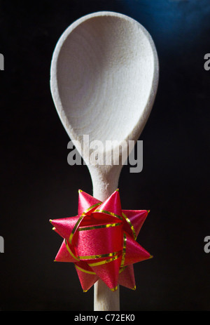 A wooden spoon with a rosette attached to the stem of the handle. Stock Photo