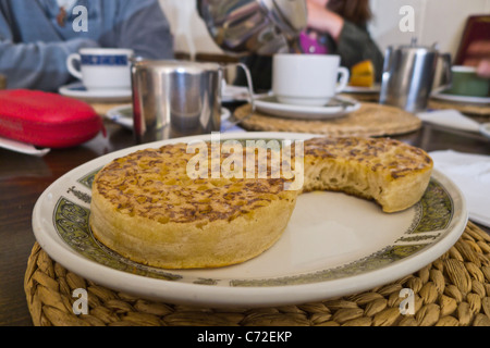 Crumpets on a plate in a teashop for afternoon tea. Stock Photo