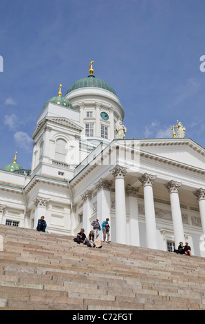 People on the steps Helsinki Cathedral, the Tuomiokirkko, in Senate Square, Helsinki, Finland Stock Photo