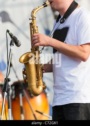 Man playing with saxophone on the concert Stock Photo