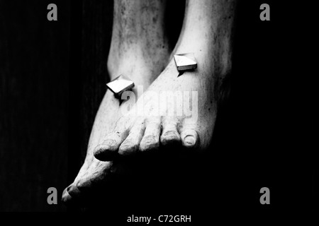 Statue of the feet of Jesus with nails at his Crucifixion in a Church in Oxford Black and White Stock Photo