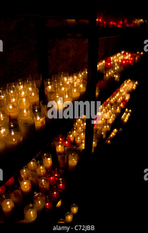 Candles lit in a Spanish sanctuary. Stock Photo