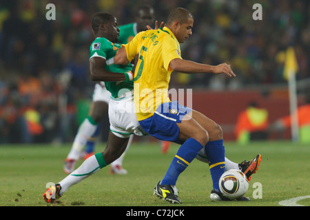Emmanuel Eboue of Côte d'Ivoire (l) defends against Felipe Melo of Brazil (r) during a 2010 FIFA World Cup soccer match. Stock Photo