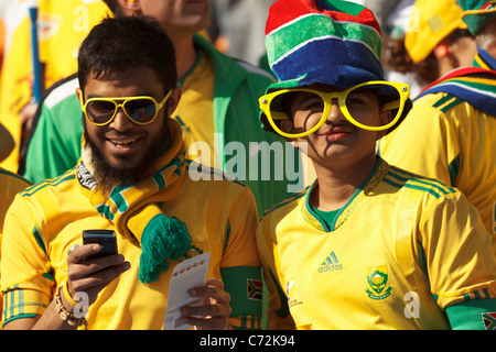 Happy South Africa supporters in the stands at Soccer City Stadium during the opening match of the 2010 FIFA World Cup. Stock Photo