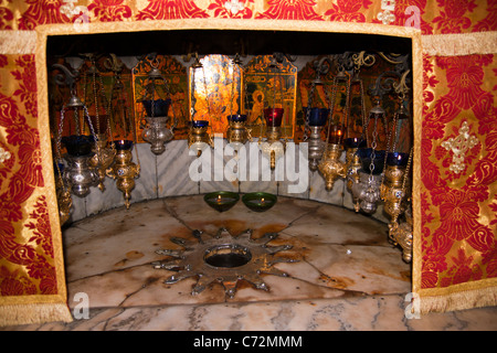 A silver star marks the traditional site of the birth of Jesus in a grotto underneath Bethlehem's Church of the Nativity. Stock Photo