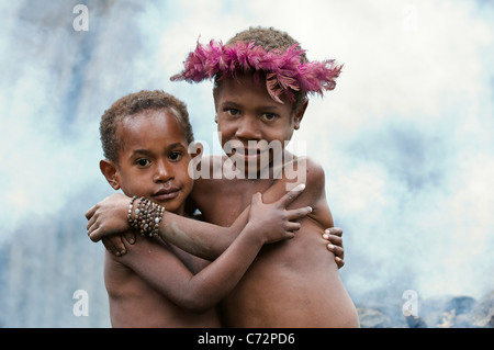 CENTRAL PAPUA, NEW GUINEA - JUNE 25: Children of a new Guinean tribe of natives Dani Dugum.Indonesia. Papua New Guinea. Village Stock Photo