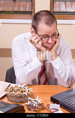 Worried businessman with cigarette Stock Photo