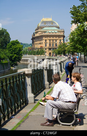 People on the bank of the Vltava river in front of the National Theater, Prague, UNESCO World Heritage Site, Czech Republic Stock Photo
